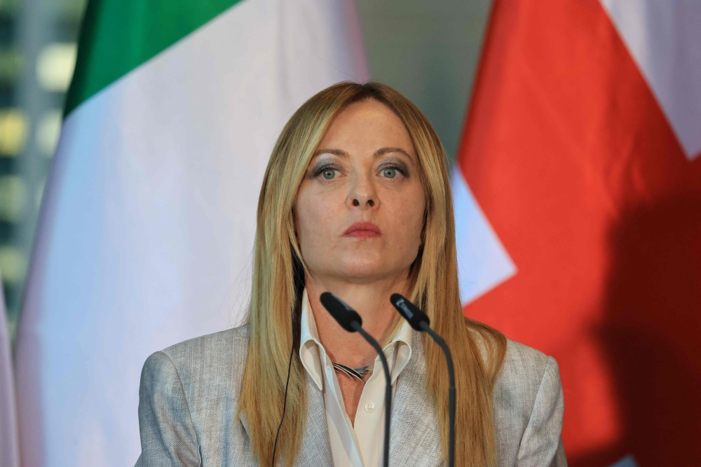 Italy's Prime Minister Giorgia Meloni addresses the press at the end of their meeting of state leaders of the European Group of Five (E5) and the NATO Secretary General, on June 24, 2026 at the Chancellery in Berlin, Germany. (Photo by Ludovic Marin / AFP)