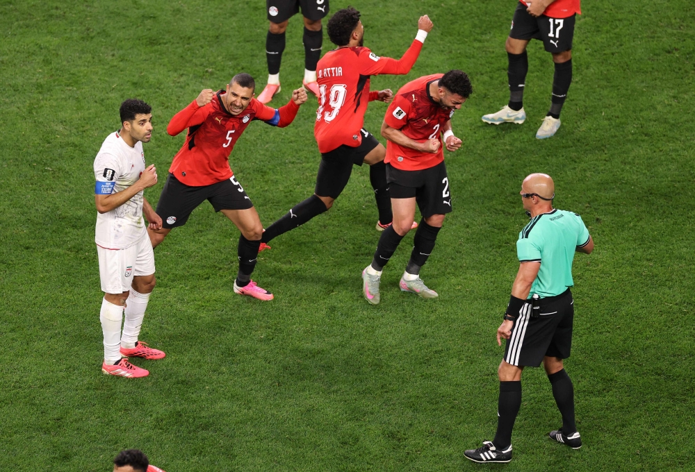 Egypt players react as referee Szymon Marciniak calls an offside violation and overturns the goal by Shoja Khalilzadeh #4 of IR Iran following a VAR review. Stu Forster/Getty Images/AFP