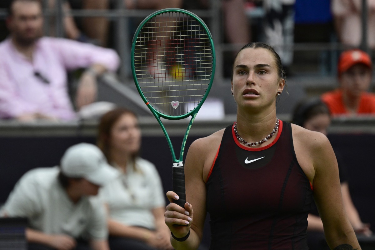 Belarus' Aryna Sabalenka walks back on the tennis court after picking up a new racket from the side as she plays against Jessica Pegula of the US during their women's singles semi-final match at the WTA500 Berlin Tennis Open tournament in Berlin on June 20, 2026. (Photo by John MACDOUGALL / AFP)