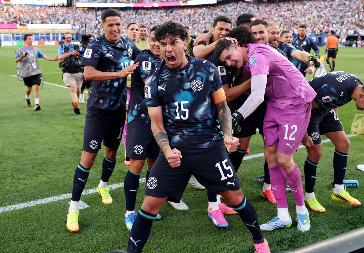 Gustavo Gomez #15 of Paraguay celebrates with teammates after Jose Canale #13 scores the winning penalty in a penalty shootout during the FIFA World Cup 2026 Round Of 32 match between Germany and Paraguay at Boston Stadium on June 29, 2026 in Foxborough, Massachusetts. (Photo by ALEXANDER HASSENSTEIN / GETTY IMAGES NORTH AMERICA / Getty Images via AFP)