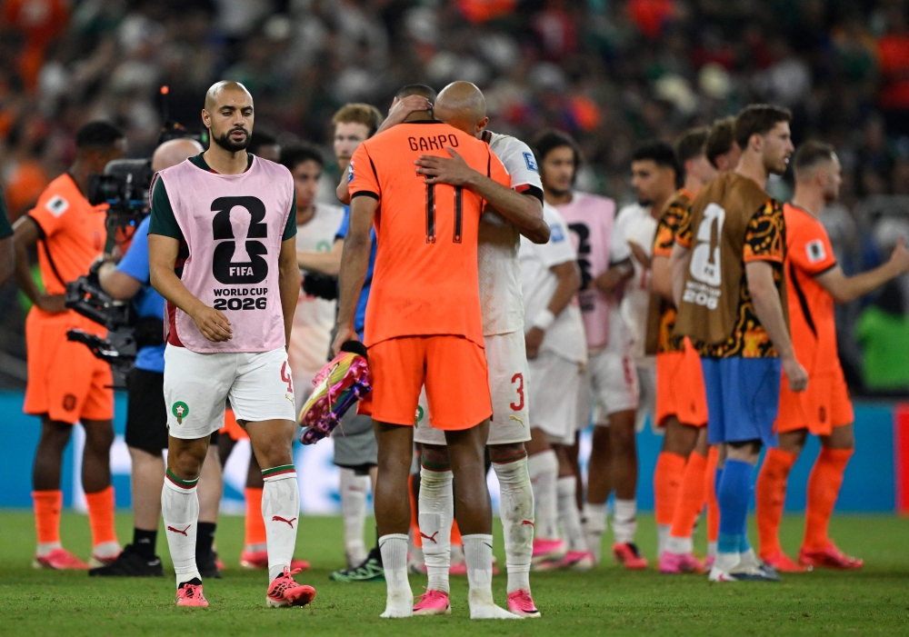 Netherlands' forward #11 Cody Gakpo is consoled by Morocco's defender #03 Noussair Mazraoui after losing the penalty shootout. (Photo by Alfredo Estrella / AFP)
 
