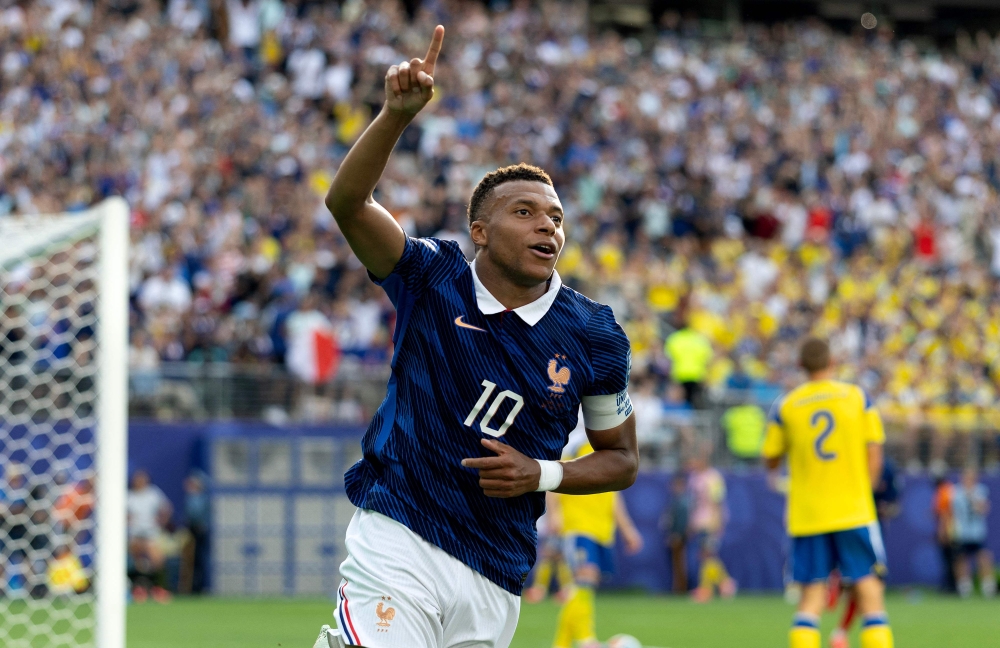 Kylian Mbappe #10 of France celebrates scoring his team's third goal. Al Bello/Getty Images/AFP
