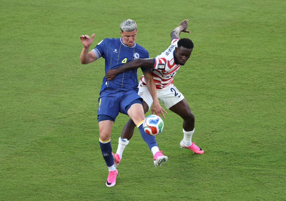 Folarin Balogun #20 of the United States fouls Tarik Muharemovic #4 of Bosnia and Herzegovina in Santa Clara, California. Michael Steele/Getty Images/AFP 