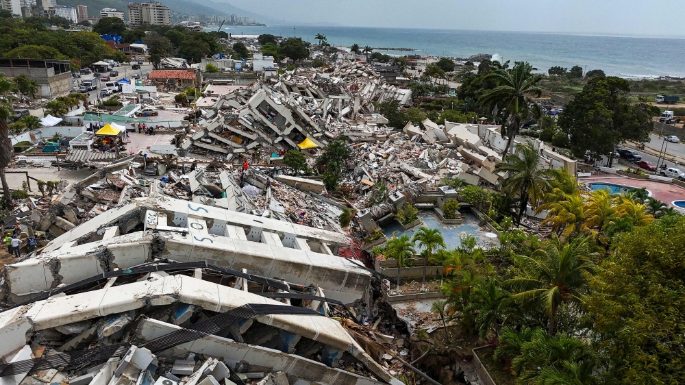 This aerial view taken on July 2, 2026, in Caraballeda in the state of La Guaira shows collapsed buildings following the June 24 twin earthquakes. (Photo by Miguel Medina / Pool / AFP)