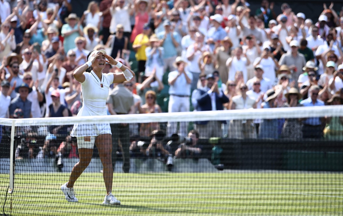 Philippines' Alexandra Eala celebrates beating Poland's Iga Swiatek during their women's singles third round tennis match on the sixth day of the 2026 Wimbledon Championships at The All England Lawn Tennis and Croquet Club in Wimbledon, southwest London, on July 4, 2026. (Photo by Henry NICHOLLS / AFP) / RESTRICTED TO EDITORIAL USE