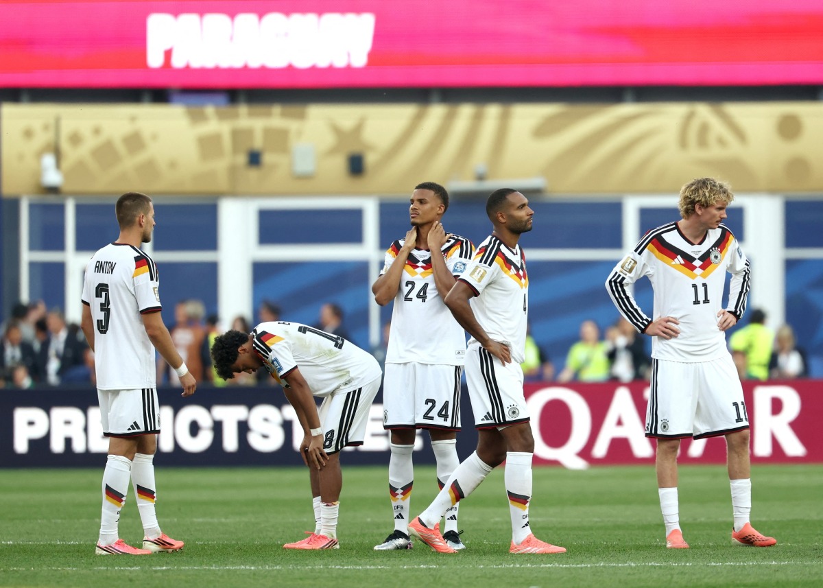 Germany’s players react after losing the penalty shootout against Paraguay.