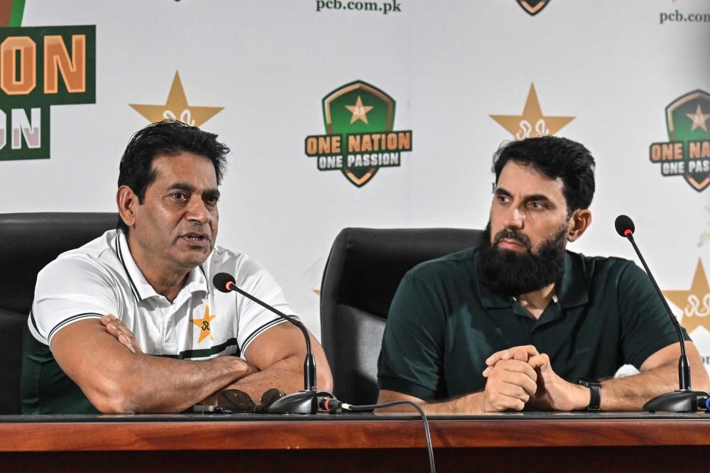 Pakistan national cricket selection committee members Aaqib Javed (L) and Misbah-ul-Haq address a press conference in Lahore on July 5, 2026.  (Photo by Arif ALI / AFP)
