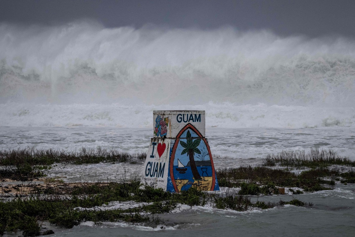 High waves crash against the coastline at a beach as the forecasted Super Typhoon Bavi approaches in Guam on July 5, 2026. (Photo by Yuichi YAMAZAKI / AFP)