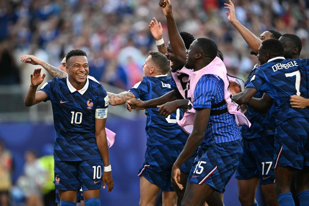 France’s Kylian Mbappe celebrates with teammates after winning the match against Paraguay. (AFP)