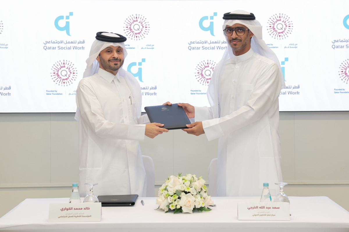 Executive Director of QCDC Saad Abdulla Al-Kharji and Deputy Chief Executive Officer of QFSW Khalid bin Mohammed Al-Kuwari exchange documents after signing of the MoU.