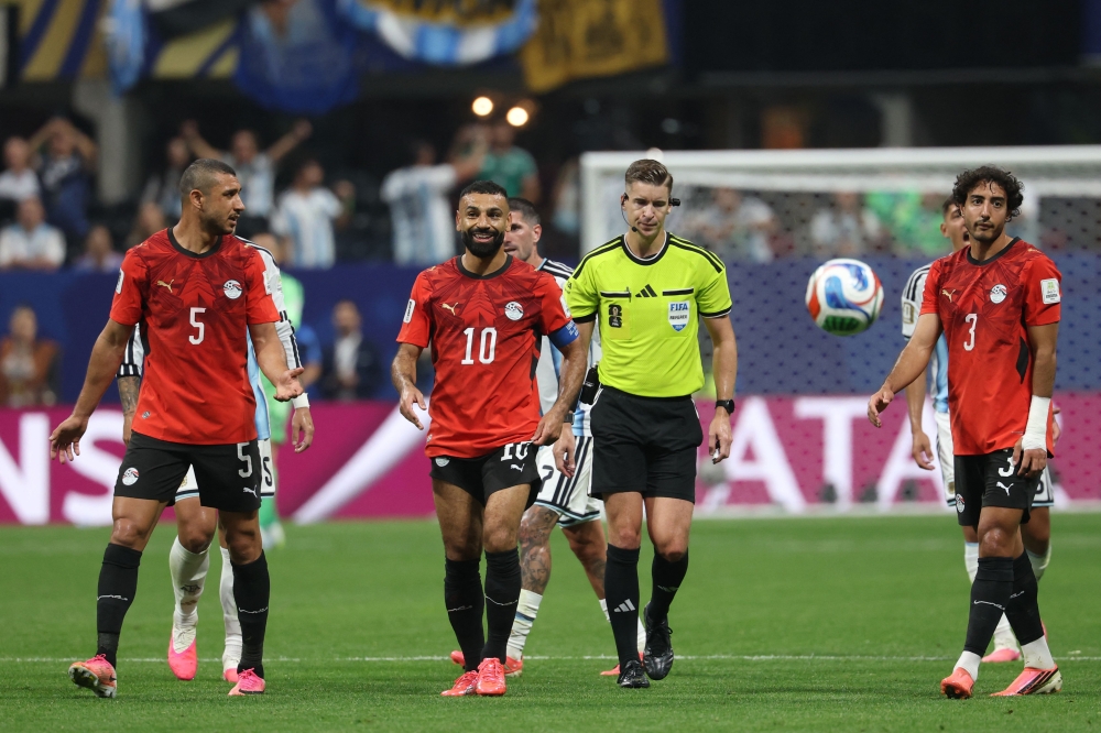 Egypt's defender #05 Ramy Rabia, forward #10 Mohamed Salah and defender #03 Mohamed Hany react during the 2026 World Cup round of 16 football match between Argentina and Egypt at Atlanta Stadium in Atlanta on July 7, 2026. (Photo by Odd Andersen / AFP)