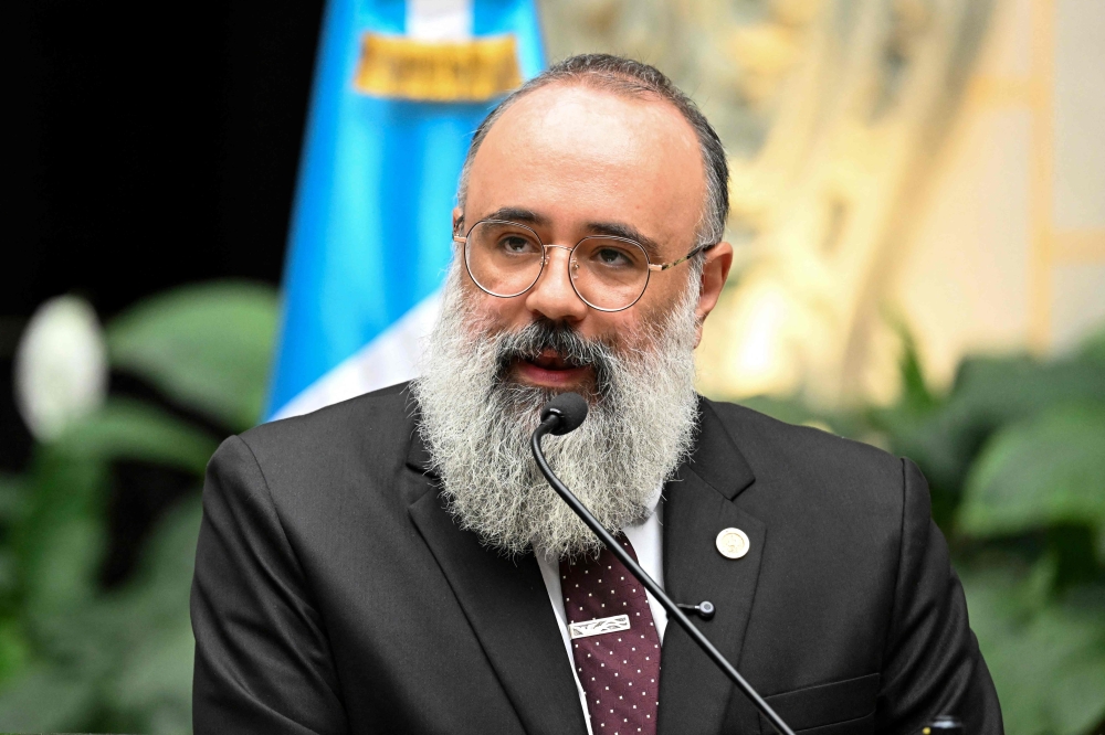 Guatemala's Minister of Culture and Sports Luis Mendez speaks during a press conference on new findings in the decipherment of hieroglyphs on Maya murals at the Xultun archaeological site, at the National Palace of Culture in Guatemala City on July 13, 2026. (Photo by Johan Ordonez / AFP)