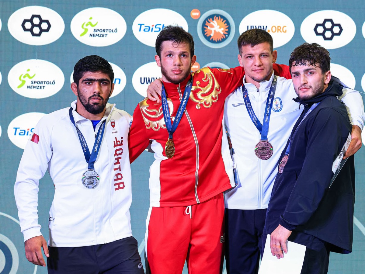 Qatar wrestler Shahin Eidimohammad Badaghimofrad (left) poses with the 82kg medal winners during the podium ceremony after claiming silver medal. 