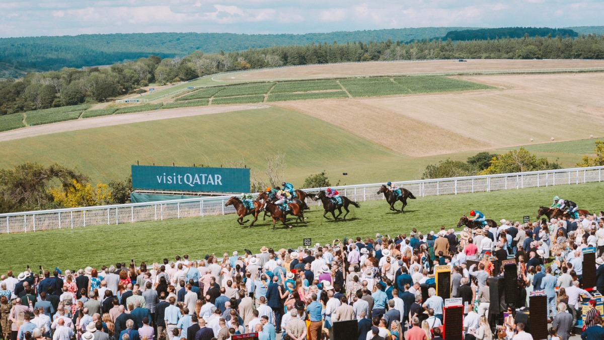 Crowds cheer as horses compete during a race at the 2025 Goodwood Festival.