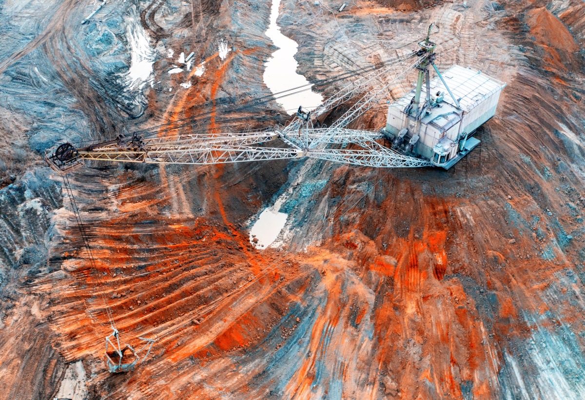 A large walking excavator works in a quarry for the extraction of rare metals. 