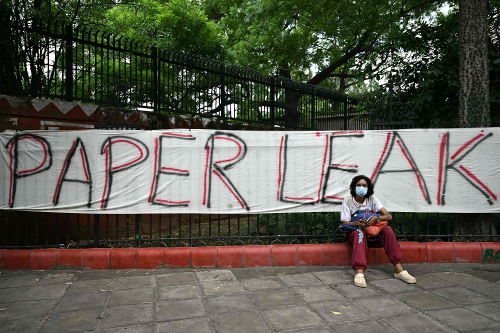 A Cockroach Janta Party (CJP) supporter sits at Jantar Mantar in New Delhi on July 23, 2026 during the ongoing protest. (Photo by Sajjad Hussain / AFP)