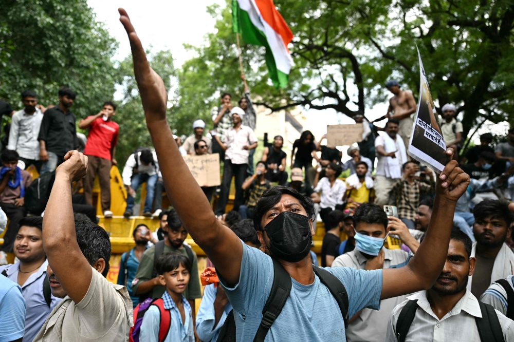 A Cockroach Janta Party (CJP) supporter shouts slogans at Jantar Mantar in New Delhi on July 23, 2026. (Photo by Sajjad Hussain / AFP)