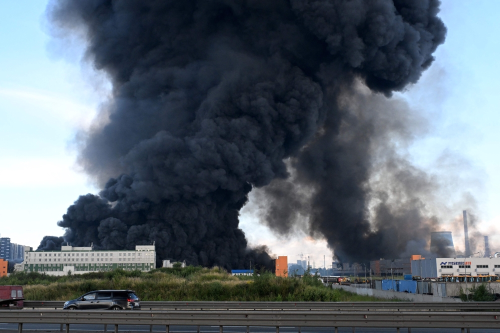 Smoke rises above a warehouse in Saint Petersburg on July 24, 2026, amid the ongoing Russian-Ukrainian conflict. (Photo by AFP)