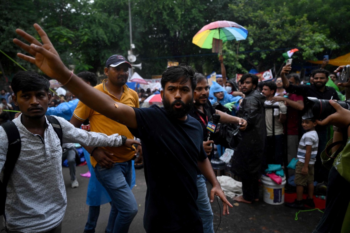 Cockroach Janta Party (CJP) founder Abhijeet Dipke speaks to the media at Jantar Mantar in New Delhi on July 24, 2026 during the ongoing protest to demand the resignation of India's Education Minister Dharmendra Pradhan over alleged NEET exam irregularities. (Photo by Arun SANKAR / AFP)