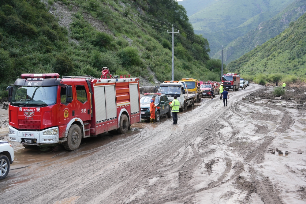 Rescuers arrive at the flood-hit scenic area in Weiyuan County, northwest China's Gansu Province, July 26, 2026. (Photo by Zhou Qiong/Xinhua)