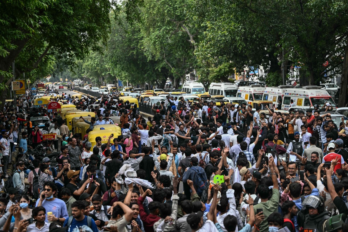Cockroach Janta Party (CJP) supporters celebrate the resignation of India's Education Minister Dharmendra Pradhan, at Jantar Mantar in New Delhi on July 25, 2026.  (Photo by Sajjad HUSSAIN / AFP)