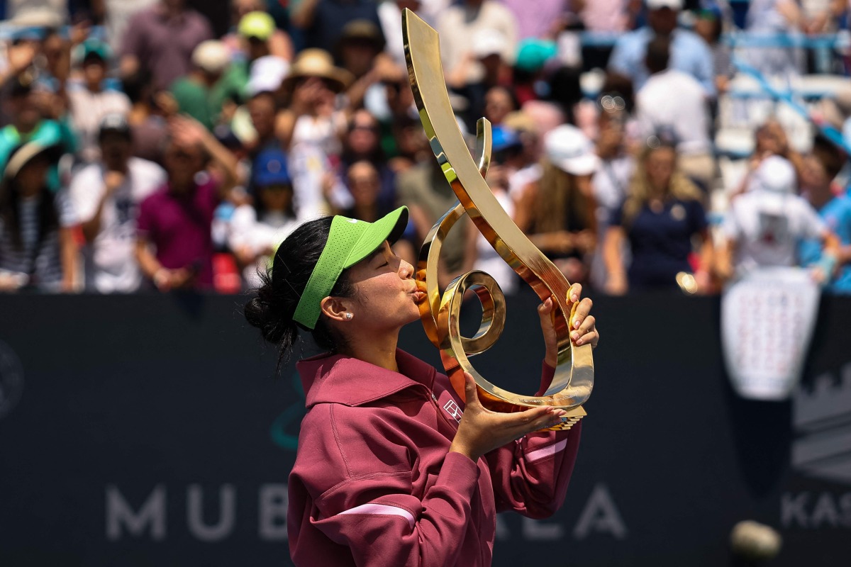 Alexandra Eala of the Philippines kisses the Championship Trophy after winning the women's singles championship match against Jessica Pegula of the United States on the final day of the Washington Open 2026 at William H.G. FitzGerald Tennis Center on August 3, 2026 in Washington, DC. (Photo by Scott Taetsch / GETTY IMAGES NORTH AMERICA / Getty Images via AFP)