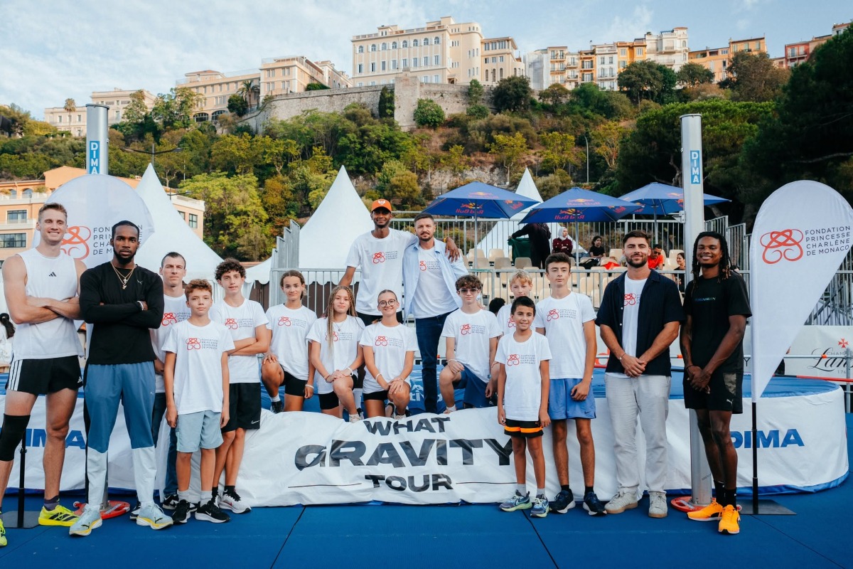 The participating high jumpers pose for a photo with junior athletes ahead of the event.