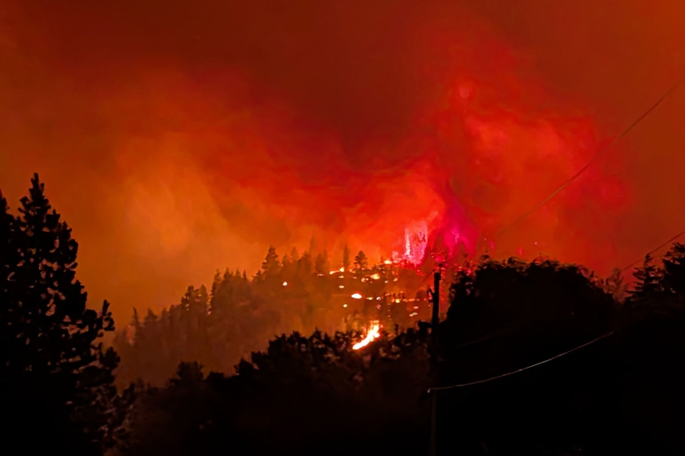 FILE PHOTO: This handout photo taken on August 7, 2026, and released on August 8 by the BC Wildlife Service shows the Bald Range wildfire near Summerland in Canada's western British Columbia province.(Photo by Handout / BC Wildfire Service / AFP) / 