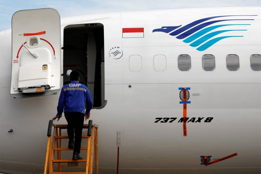 Reuters file photo for representation showing a technician boarding a parked Garuda Indonesia airplane.