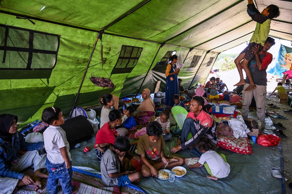 Villagers rest in a tent on an open field in Marapokot, Nagekeo, East Nusa Tenggara, on August 17, 2026, following a 7.7-magnitude earthquake. T (Photo by JUNI KRISWANTO / AFP)