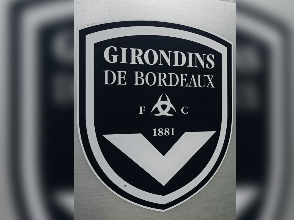 (FILES) This general view taken on May 19, 2022, shows a sign with a logo in front of the chateau of FC Girondins de Bordeaux at the club's training ground in Le Haillan, near Bordeaux, south-western France. (Photo by Philippe LOPEZ / AFP)