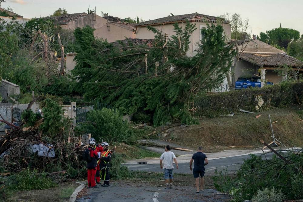 This photograph taken on August 24, 2026, shows damaged houses and toppled trees after a tornado struck Pomas, southwestern France. (Photo by Idriss Bigou-Gilles / AFP)