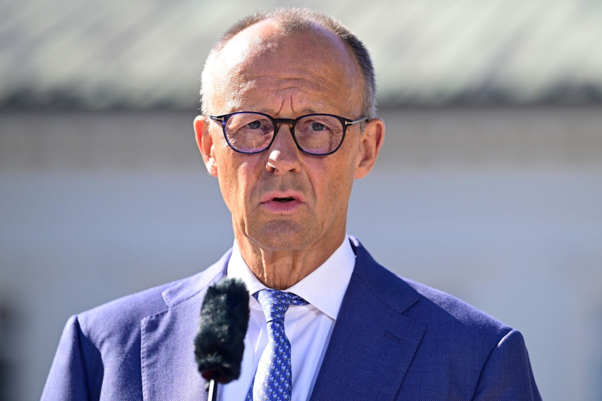 German Chancellor Friedrich Merz gives a statement prior to the start of a retreat meeting of the German cabinet on August 25, 2026 in Neuhardenberg, northeastern Germany. (Photo by John MACDOUGALL / AFP)