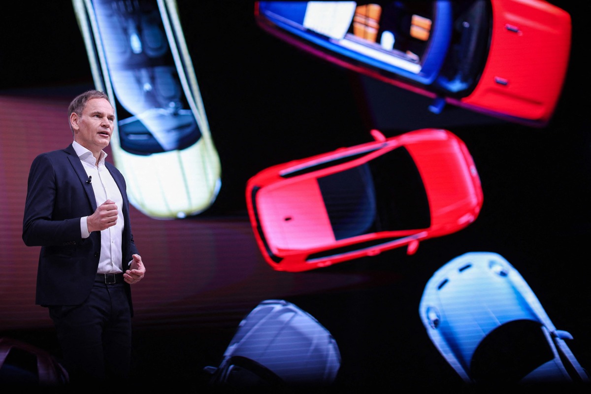 (FILES) German carmaker Volkswagen (VW) CEO Oliver Blume addresses an annual news conference to present the company's results at the company's headquarters in Wolfsburg, central Germany, on March 11, 2025. (Photo by Ronny HARTMANN / AFP)