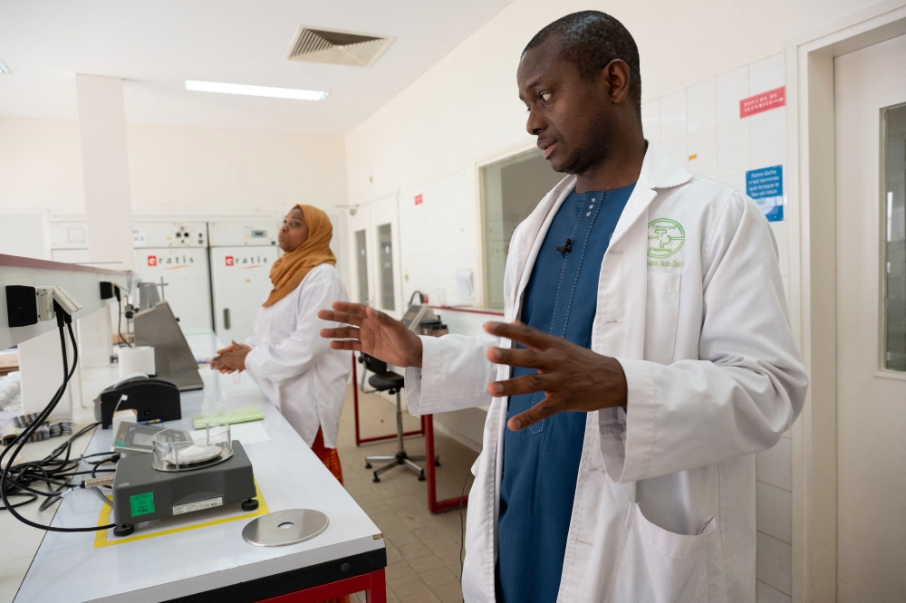 Senegalese pharmacist and Teranga Pharma CEO Dr. Mouhamadou Sow shows one of his laboratories during an interview in Mbao. (Photo by SEYLLOU / AFP)
