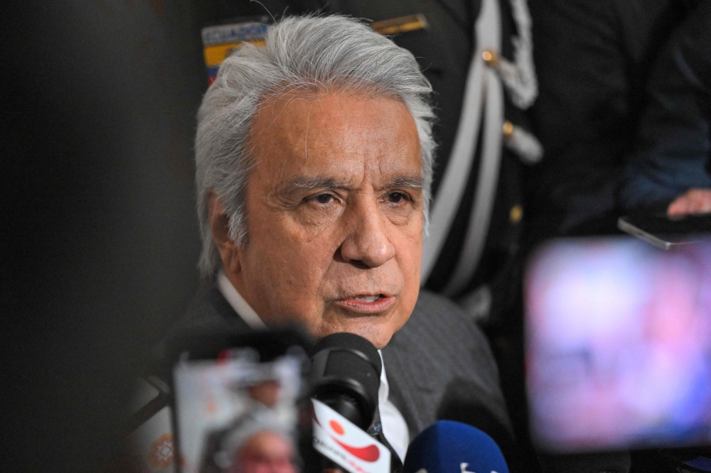 (FILES) Ecuador's former president (2017–2021) Lenin Moreno speaks with the media as he leaves the National Court of Justice over a corruption case in Quito, on May 11, 2026.  (Photo by Rodrigo BUENDIA / AFP)