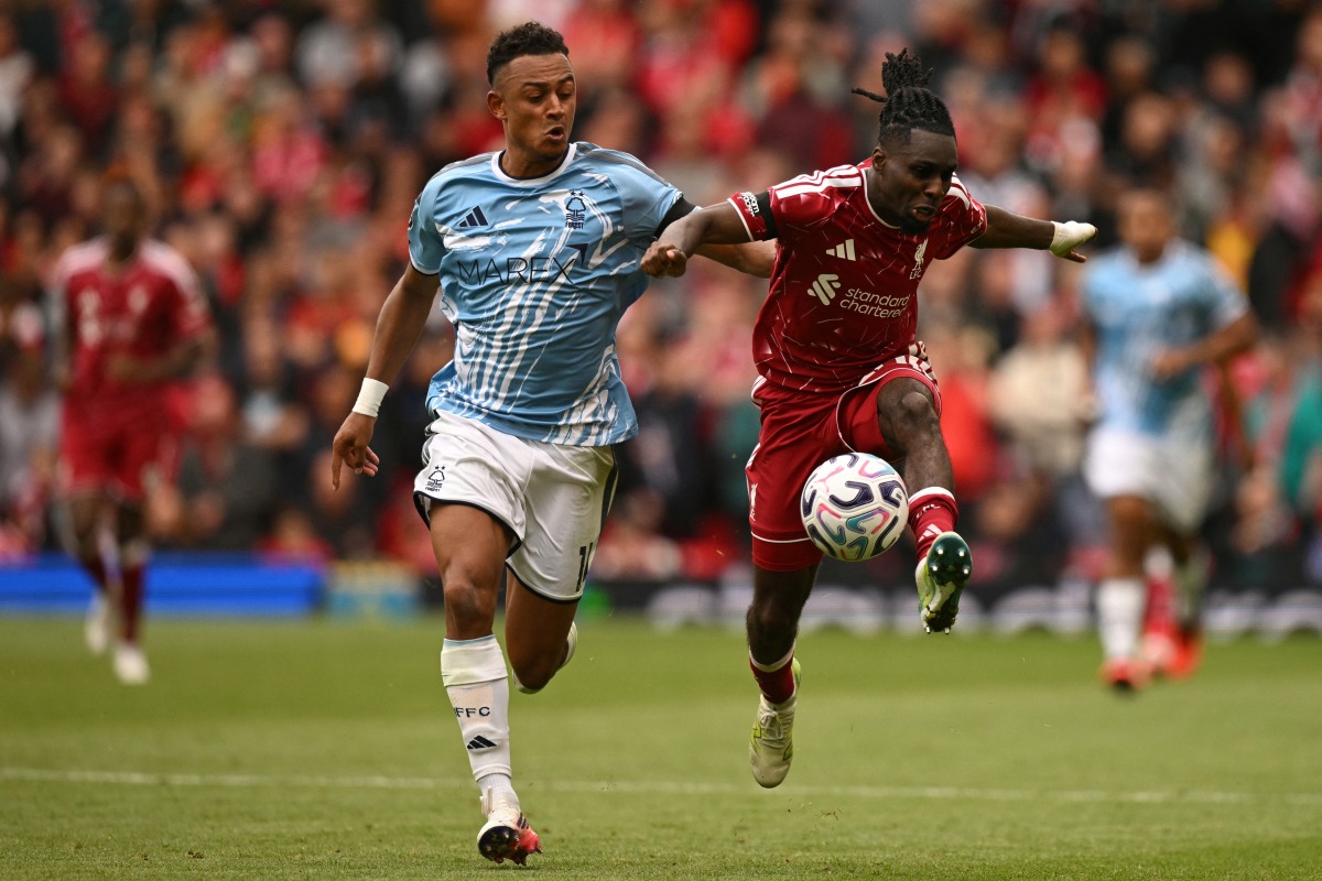 Nottingham Forest's Swiss midfielder #11 Dan Ndoye (L) vies with Liverpool's Dutch defender #30 Jeremie Frimpong (R) during the English Premier League football match between Liverpool and Nottingham Forest at Anfield in Liverpool, north west England on August 29, 2026. (Photo by Oli SCARFF / AFP)