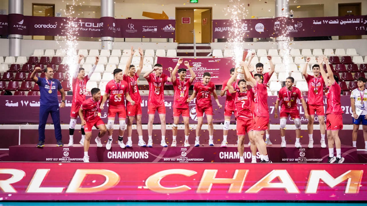 Iran players celebrate with the trophy after beating France in the final.