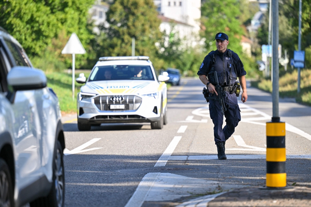 Police officers secure the area where a shooting occurred, in Aarau, northern Switzerland, on 30 August 2026 (Photo by Harold CUNNINGHAM / AFP)
 