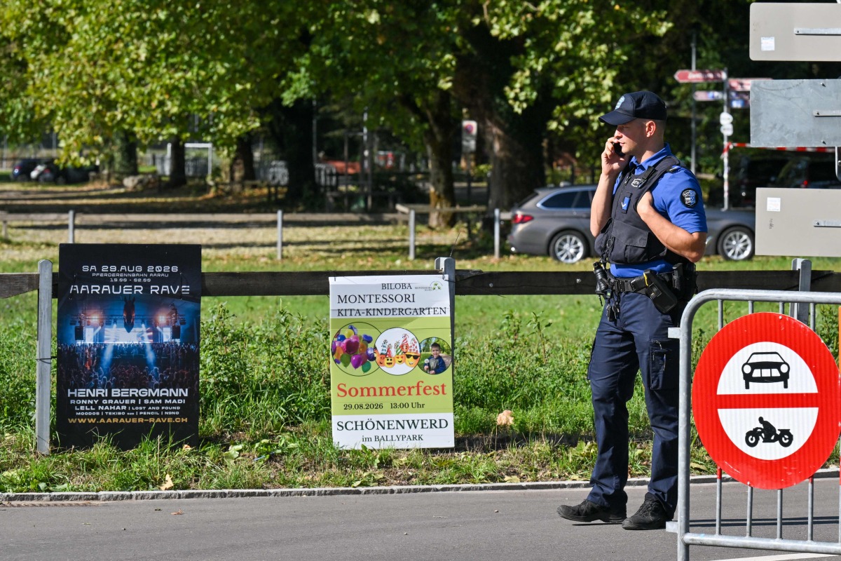 Police officers secure the area next to a poster advertising a rave where a shooting occurred, in Aarau, northern Switzerland, on August 30, 2026. Photo by Harold CUNNINGHAM / AFP