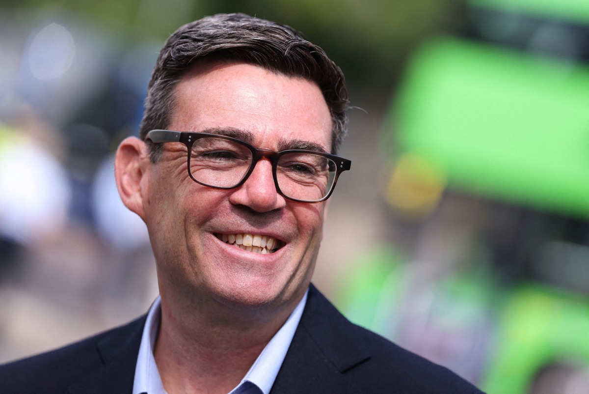 Britain's Prime Minister Andy Burnham smiles during a visit to Bath, western England, on July 22, 2026. Photo by Toby Melville / POOL / AFP