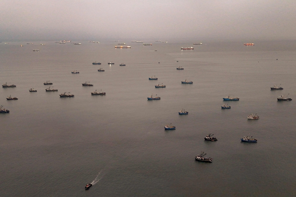Aerial view shows anchovy fishing boats anchored off the coast in front of the Constitutional Province of Callao, Peru on August 31, 2026. (Photo by Ernesto BENAVIDES / AFP)
 