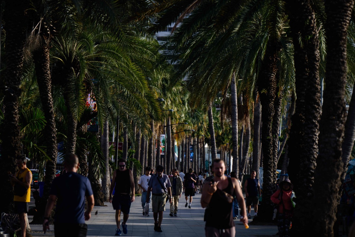 Visitors walk along a promenade that runs along Pattaya Beach in Pattaya on September 1, 2026. Photo by ANTHONY WALLACE / AFP