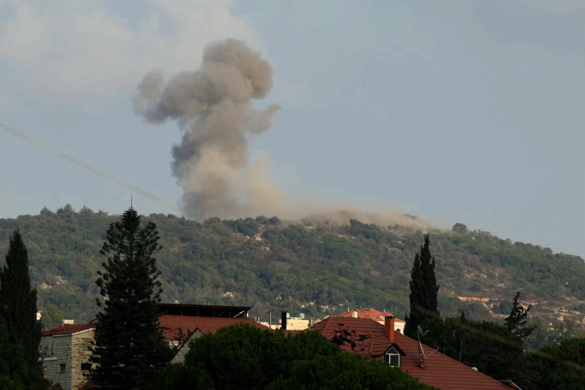 (FILES) A photograph taken from the southern Lebanese area of Nabatieh shows smoke as it rises from the site of Israeli strikes that targeted the hilltops of the mountainous area of the strategic Ali al-Taher Ridge on August 14, 2026. (Photo by AFP) /