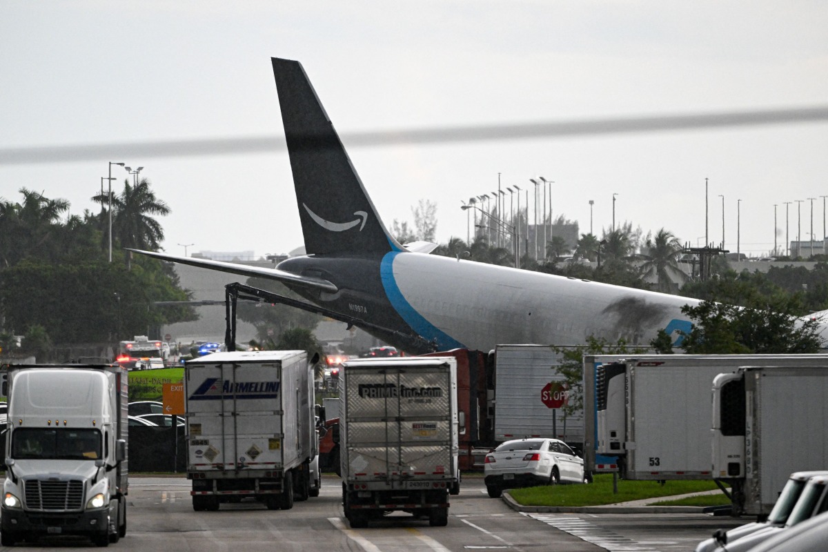 The tail section of a cargo plane is seen at Miami International Airport after it overran the runway at Miami International Airport in Miami, Florida, on September 6, 2026. (Photo by CHANDAN KHANNA / AFP)