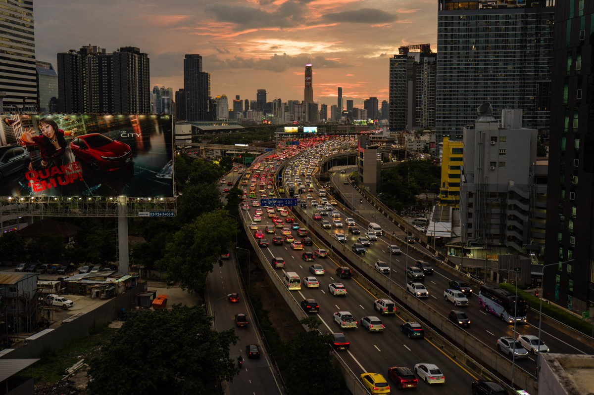 Commuters drive past commercial and residential buildings during the early evening rush hour traffic in Bangkok on September 4, 2026. (Photo by Anthony WALLACE / AFP)
