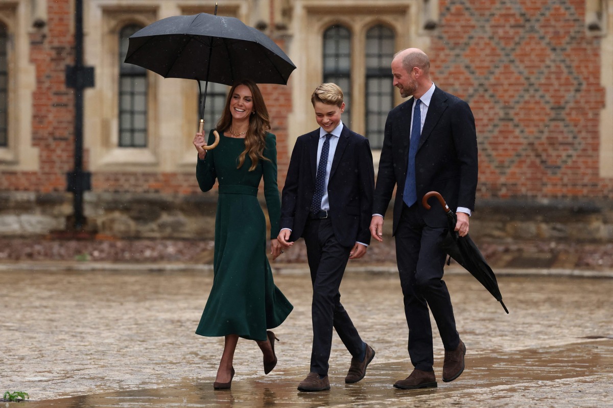 Britain's Catherine, Princess of Wales (L) and Britain's Prince William, Prince of Wales (R) walk with their 13-year-old son, Britain's Prince George of Wales (C), as he arrives for his first day at Eton College, in Eton, west of London, on September 8, 2026. (Photo by Adrian DENNIS / POOL / AFP)