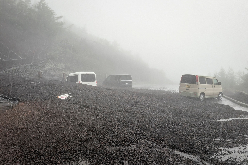 This handout photo taken on September 9, 2026 and received from Shizuoka prefecture on September 10, 2026 shows vehicles buried by mud and debris after a landslide swept into the parking lot at Fifth Station of Mount Fuji's Fujinomiya Trail in Fujinomiya, Shizuoka Prefecture. (Photo by Shizuoka Prefecture / AFP)