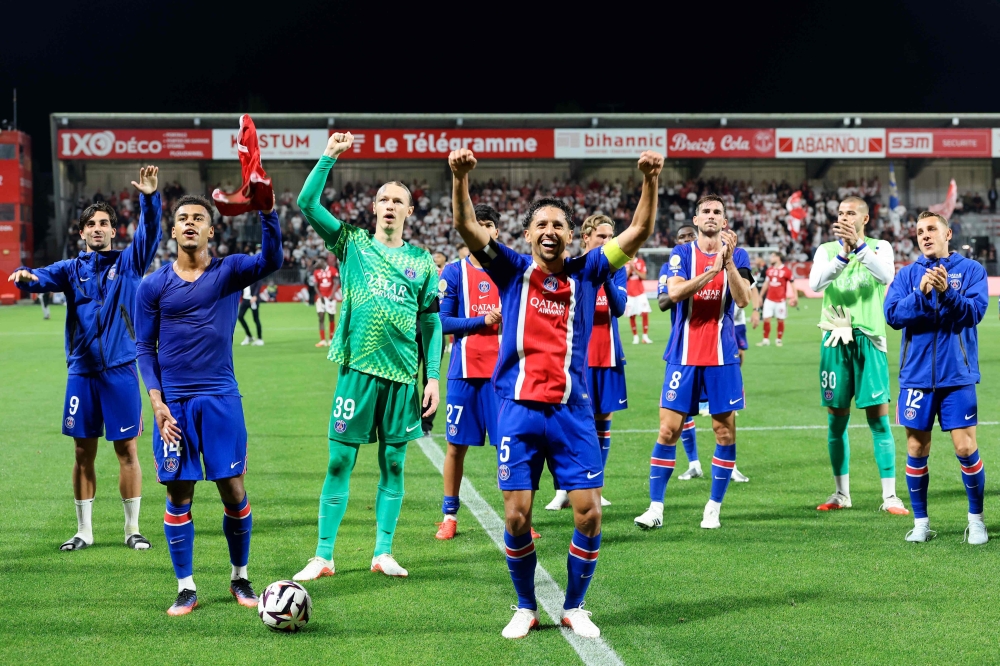 (From L) Paris Saint-Germain's French midfielder #14 Desire Doue, Russian goalkeeper #39 Matvey Safonov, Brazilian defender #05 Marquinhos and defender #03 Lucas Digne celebrate their victory at the end of the French L1 football match between Stade Brestois 29 and Paris Saint-Germain (PSG) at the Stade Francis-Le Ble in Brest on September 13, 2026. (Photo by FRED TANNEAU / AFP)