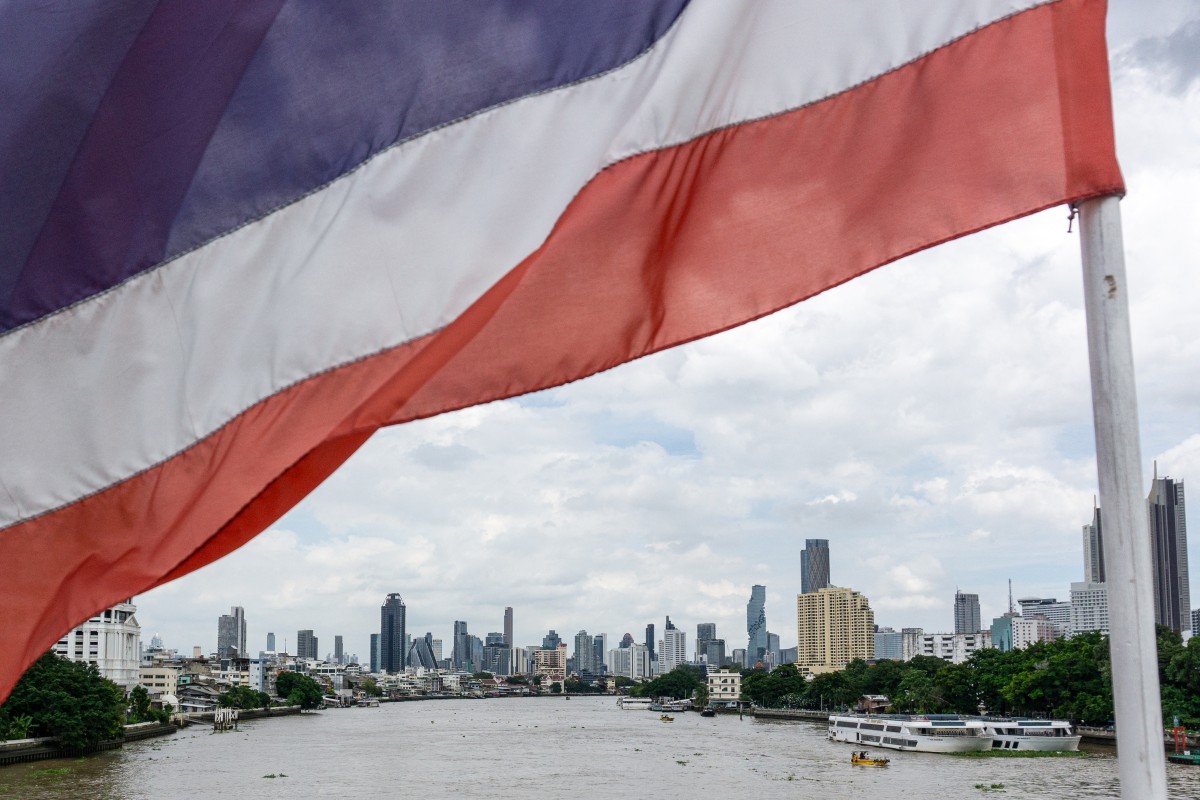 A national flag of Thailand flutters in the wind with the city skyline in the background in Bangkok on September 9, 2026. (Photo by Amaury PAUL / AFP)